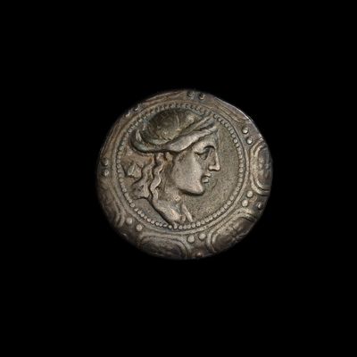gros plan d'une pièce de monnaie sur laquelle figure un visage de femme