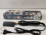 a close up of a hair brush and comb on a table