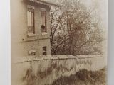 an old photo of an old building with a tree in front of it