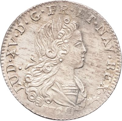 gros plan d'une pièce de monnaie sur laquelle figure une tête de femme