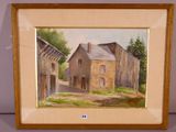 painting of an old house in a wooden frame on a table