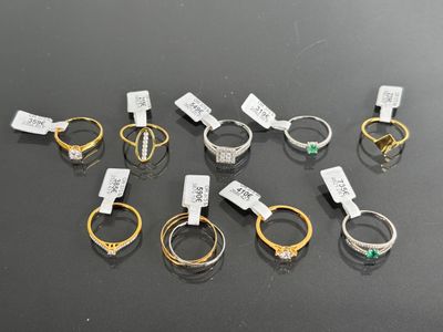 several different types of rings with tags on them on a table