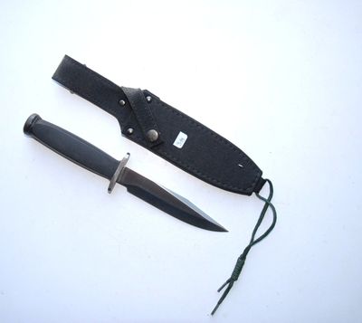 a knife that is laying next to a knife sheath