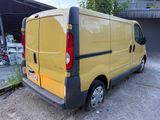 a yellow van that is parked in a parking lot