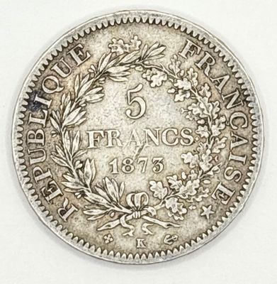 a close up of a coin on a white surface