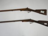 a pair of winchester rifles,