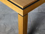 a close up of a wooden table with a black stripe
