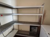 a white refrigerator and some shelves in a room