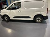 the white van is parked in the garage with the door open