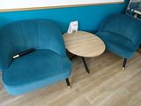 two chairs and a table in the corner of a room