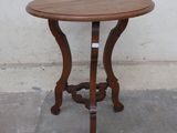 a small table with a wooden top on a concrete floor