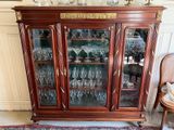 a glass cabinet with a lot of wine glasses in it