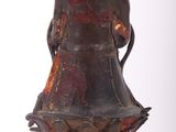 a brown vase with a red and black design on it