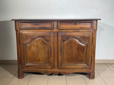 a wooden cabinet that is sitting on a tiled floor