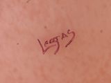 a close up of a woman ' s stomach with a tattoo on it
