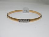 a gold bracelet with a diamond bar on it