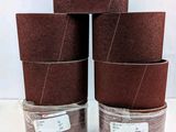 a set of four brown sandpaper rolls sitting on top of each other