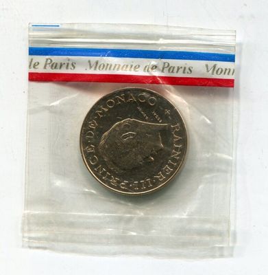 a small coin in a plastic bag on a white surface