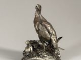 silver plated figurine of a pheasant on a nest