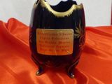 a small black vase with a gold decoration on it