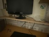an image of a computer desk with a monitor and keyboard