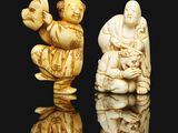 two carved ivory figurines of a man and a woman
