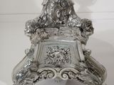 a silver candle that is on top of a table