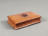 an image of a small wooden box with a coin on top of it