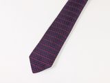 purple and red necktie on a white surface with a white background