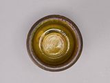 a small glass bottle with a coin inside of it