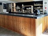 a picture of a bar with a lot of bottles on the counter