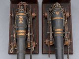 pair of antique fire extinguisors mounted on a wall