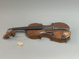 a violin that is sitting on a table with a dice