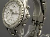 an image of a close up of a wrist watch on a stand