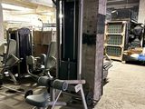 a gym room with equipment in the middle of the room