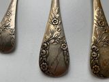 four spoons and two spoons on a table