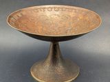 an antique bronze bowl with a decorative design on it