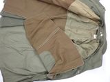 a jacket that is laying on top of a bed