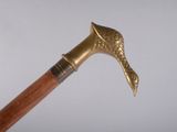 a very old wooden stick with a metal handle