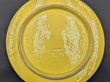 an image of a yellow plate on a black table