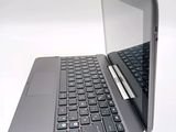 a laptop with a pen sitting on top of it