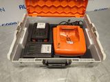 an orange case with two batteries and a charger in it