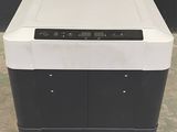 an image of a black and white refrigerator sitting on top of a tiled floor