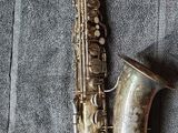 a saxophone that is laying on a blanket