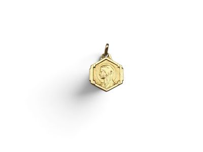 a small gold coin with a woman ' s face on it