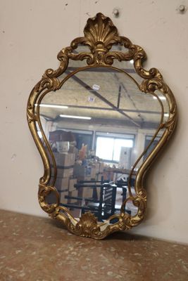 a mirror that is sitting on a table in a room