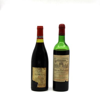 two bottles of wine sitting next to each other on a white surface