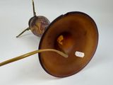 a lamp that is sitting on a table with a stick