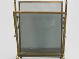 an old brass magazine rack with a glass door and a mirror
