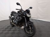 a black motorcycle that is parked in a room